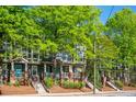 Charming townhomes with brick accents, stairs, and lush green trees at 1112 Park S Row, Atlanta, GA 30312
