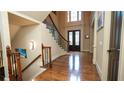 Grand foyer featuring hardwood floors, elegant staircase, and double front doors at 2698 Bonar Hall Path, Duluth, GA 30097