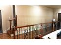 Second floor hallway with wooden railing and views of the main floor below at 2698 Bonar Hall Path, Duluth, GA 30097