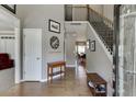 Inviting foyer with hardwood floors, a staircase with iron balusters, and natural light streaming in at 1673 Chadwick Ridge Dr, Lawrenceville, GA 30043