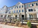 Charming townhome exterior with fenced yard and landscaped front at 540 Sawnee Village Blvd # D68, Cumming, GA 30040