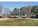 Quaint one-story home featuring a spacious lawn and modern appeal at 6370 Boca Grande Blvd, Forest Park, GA 30297