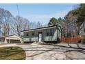 Well-kept home with a spacious driveway and manicured lawn at 6370 Boca Grande Blvd, Forest Park, GA 30297
