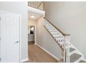 Inviting foyer showcasing hardwood floors and staircase with decorative white banister at 1561 Cooks Pond Dr, Powder Springs, GA 30127