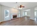 Bright living room with fireplace, ceiling fan, and seamless flow to the dining area at 1561 Cooks Pond Dr, Powder Springs, GA 30127