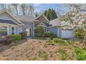 Charming single-Gathering home featuring stone accents, a two-car garage, and a meticulously landscaped front yard at 534 Creekstone Dr, Jonesboro, GA 30236