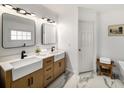 Stylish bathroom featuring dual sinks with modern fixtures, marble tile flooring, and ample counter space at 570 Glen Eagles Se Cir, Marietta, GA 30067