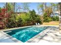 Refreshing backyard pool with lounge chairs, perfect for relaxing and soaking up the sun in a private setting at 570 Glen Eagles Se Cir, Marietta, GA 30067