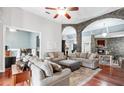 Spacious living room featuring stone arches, fireplace, hardwood floors and lots of seating at 12551 Alcovy Rd, Covington, GA 30014