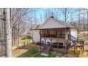 Two-story screened deck boasts outdoor seating and a hot tub overlooking the backyard at 416 Delane Dr, Dallas, GA 30157