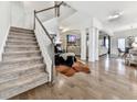 Inviting entryway with hardwood floors, staircase, and an open floor plan leading into the living area at 134 Edinburgh Dr, Canton, GA 30115