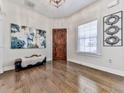 Bright entryway featuring wood-look tile flooring, a decorative mirror, and a rustic wooden front door at 134 Edinburgh Dr, Canton, GA 30115