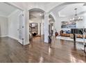 Elegant living room with hardwood floors, fireplace, and arched doorways with supporting pillars at 134 Edinburgh Dr, Canton, GA 30115