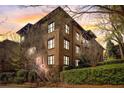Multi-story brick condo with multiple levels of balconies offering neighborhood views at sunset at 5910 Bond St # 401, Cumming, GA 30040
