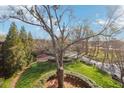 Landscaped yard with mature trees, lush lawns, and views of the neighborhood beyond, under a blue sky at 5910 Bond St # 401, Cumming, GA 30040