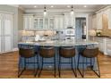 Gourmet kitchen with large center island, granite countertops, and modern appliances at 305 Inman Pl, Roswell, GA 30075