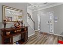 Welcoming home foyer with hardwood floors, elegant decor, and a view of the staircase and front door at 345 Timber Gate Court, Lawrenceville, GA 30045