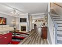 Bright living room with a cozy fireplace, modern flooring, and a staircase leading to the upper level at 345 Timber Gate Court, Lawrenceville, GA 30045
