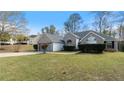 Traditional home with brick and siding, complemented by a green lawn and neatly trimmed shrubbery at 3191 Mineral Ridge Ln, Stone Mountain, GA 30087