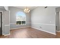 Well-lit living room featuring hardwood floors, large arched window, and neutral paint, creating an inviting space at 3191 Mineral Ridge Ln, Stone Mountain, GA 30087