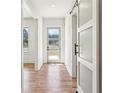 Inviting hallway with hardwood floors, sliding doors and a view of the front door at 478 Majestic Oaks Pl, Smyrna, GA 30082