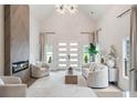 Airy living room featuring vaulted ceilings, fireplace, large windows, and modern decor at 1035 Walker Se Ave, Atlanta, GA 30316