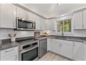 Modern kitchen with white cabinets, stainless steel appliances, and ample counter space at 1088 Riverbend Club Se Dr, Atlanta, GA 30339