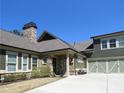 Charming home featuring stone accents, a stone chimney, and a convenient three-car garage at 118 Cedarcrest Village Ct, Acworth, GA 30101