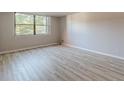 A bright bedroom with light wood flooring and a large window at 2965 Pharr Court South Nw # 518, Atlanta, GA 30305