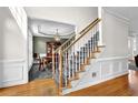 Beautiful foyer with a hardwood floor and a staircase with carpeted steps and wooden handrail at 269 Hidden Wood Ct, Lawrenceville, GA 30043