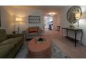 Comfortable living room boasts neutral furnishings, decorative art, and a view into the kitchen area at 3668 Kingsboro Ne Rd # 6, Atlanta, GA 30319