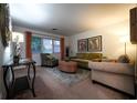 Inviting living room featuring neutral walls, patterned armchairs, a cozy ottoman, and warm lighting at 3668 Kingsboro Ne Rd # 6, Atlanta, GA 30319