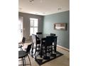 Eat-in kitchen boasts a table with four chairs, a window, and a black and white checkered floor at 4528 Baker Grove Nw Rd, Acworth, GA 30101