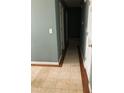 Hallway with hardwood floors on the side, and off-white tile on the interior of the hall at 4528 Baker Grove Nw Rd, Acworth, GA 30101