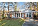 Inviting brick home showcasing a well-kept lawn and freshly painted white trim at 2299 Brenda Se Dr, Smyrna, GA 30080