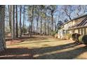 Expansive backyard with mature trees and a well-kept lawn, providing ample space for outdoor activities and relaxation at 3281 Old Salem Rd, Conyers, GA 30013