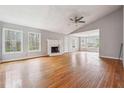 Spacious living room with a fireplace, multiple windows, and hardwood floors at 845 James Path Ct, Lawrenceville, GA 30044