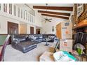 Spacious living room with high ceilings, beams, stone fireplace, and plush seating at 270 Oak Ridge Rd, Covington, GA 30016