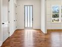 Elegant entryway featuring hardwood floors, white trim, and a stylish front door with side windows at 482 Majestic Oaks Pl, Smyrna, GA 30082