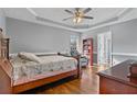 Inviting bedroom with tray ceilings, hardwood floors, and a cozy reading nook at 633 Windy Mill Xing, Temple, GA 30179