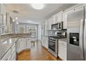Modern kitchen with stainless steel appliances, granite countertops, and white cabinetry at 633 Windy Mill Xing, Temple, GA 30179