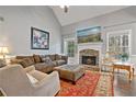 Comfortable living room featuring a stone fireplace, high ceilings, and abundant natural light at 633 Windy Mill Xing, Temple, GA 30179