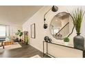 Bright entryway featuring hardwood floors, stylish decor, and an open view to the living room at 3058 Yellowhammer Dr, Marietta, GA 30064