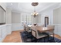 Dining room with hardwood floors, a decorative chandelier, and views of the landscaped yard at 4126 Gold Mill Rdg, Canton, GA 30114