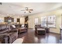 Open-concept living space with hardwood floors and lots of light adjacent to the kitchen and exit to exterior at 307 Montgomery Way, Woodstock, GA 30188