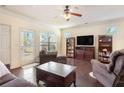 Comfortable living room featuring hardwood floors, bright windows, and cozy seating at 307 Montgomery Way, Woodstock, GA 30188