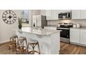 Kitchen with stainless steel appliances, granite countertops and kitchen island with barstool seating at 102 Hill Side Ln, Dallas, GA 30157