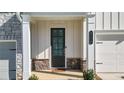 Inviting front entrance showcases a stylish door, stone accents, and well-manicured landscaping at 2128 Cosette Ln, Kennesaw, GA 30152