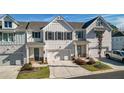 Charming townhome featuring a welcoming front exterior, private driveways, and attached garages at 2128 Cosette Ln, Kennesaw, GA 30152