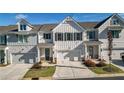 Beautiful exterior of a townhome with a driveway, garage, and well-maintained landscaping at 2128 Cosette Ln, Kennesaw, GA 30152